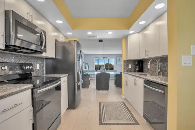 a kitchen with a refrigerator sink and microwave
