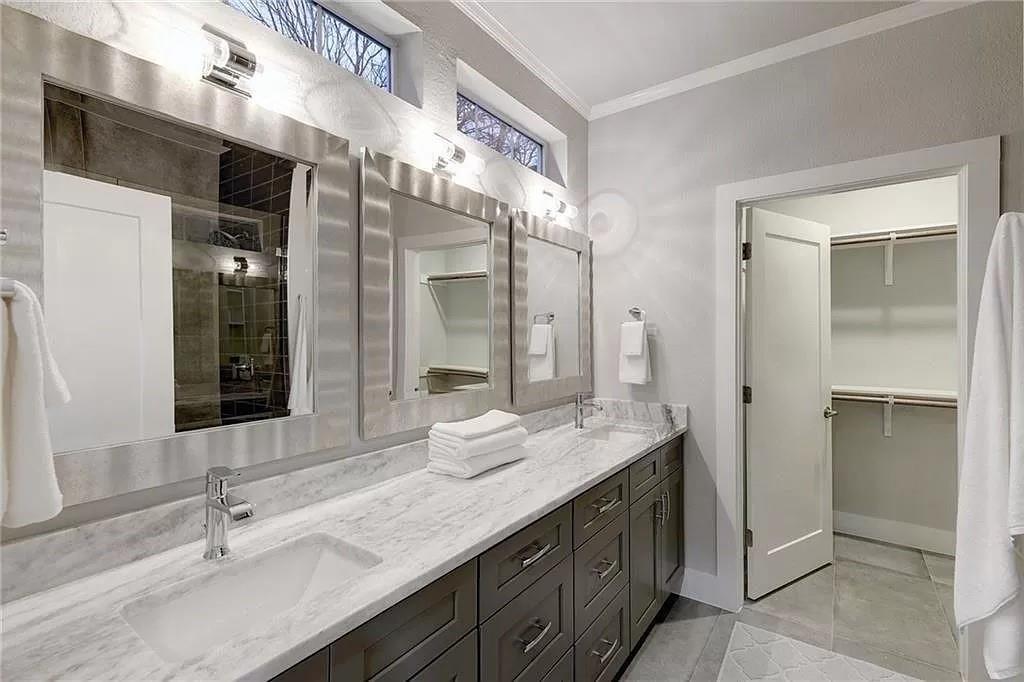 1217 Eleanor Street Austin, TX 78721 - Photo 11 of 17 Full bath with ornamental molding, double vanity, a spacious closet, light tile patterned floors, and an enclosed shower