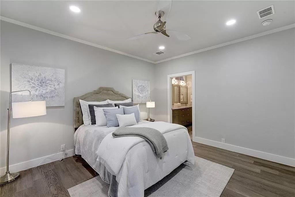 1217 Eleanor Street Austin, TX 78721 - Photo 10 of 17 Bedroom with crown molding, wood finished floors, recessed lighting, a ceiling fan, and connected bathroom