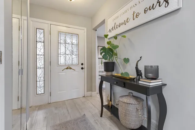 a view of a workspace with furniture and a window