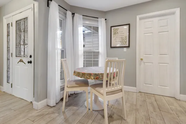 a dining room with furniture and window