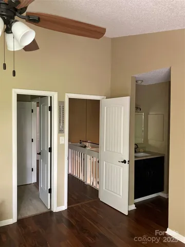 a view of a hallway with wooden floor