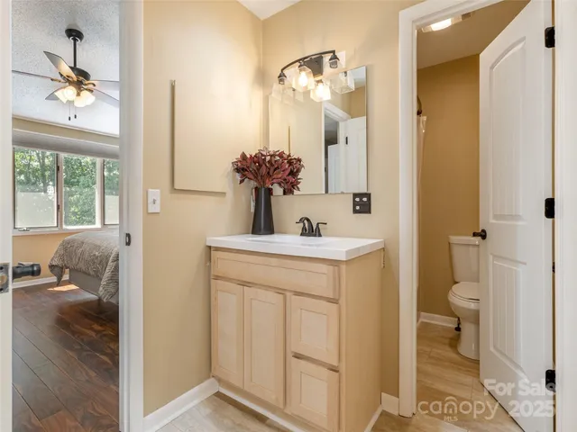 a en suite bathroom with a toilet sink and a mirror