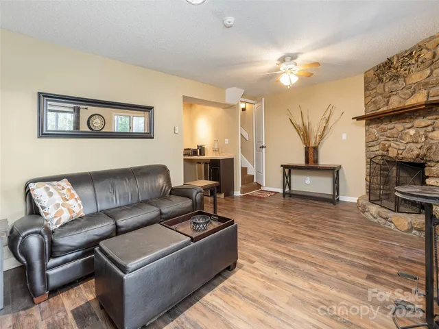 a living room with furniture and a fireplace