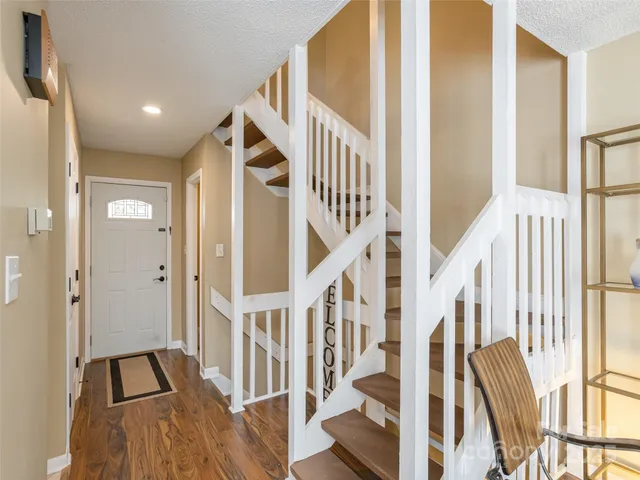 a view of an entryway with wooden floor and door