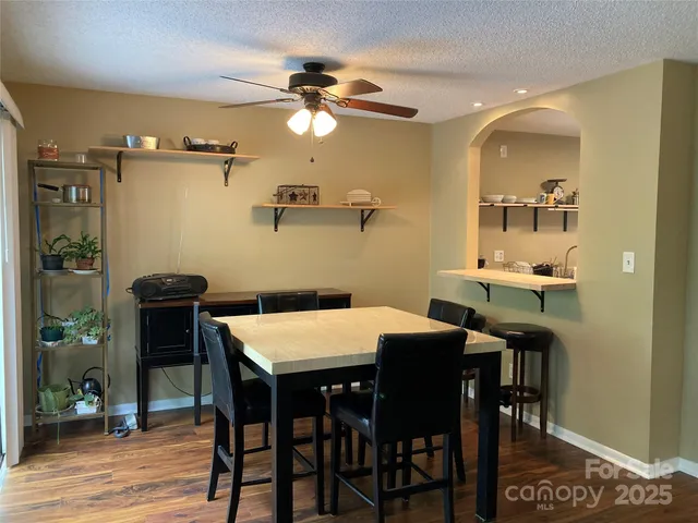 a view of a dining room with furniture and wooden floor
