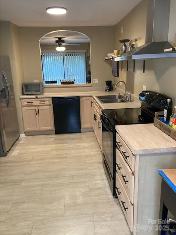 a kitchen with stainless steel appliances granite countertop a stove and a sink