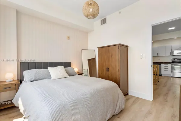 a bedroom with a bed and painting on the wall