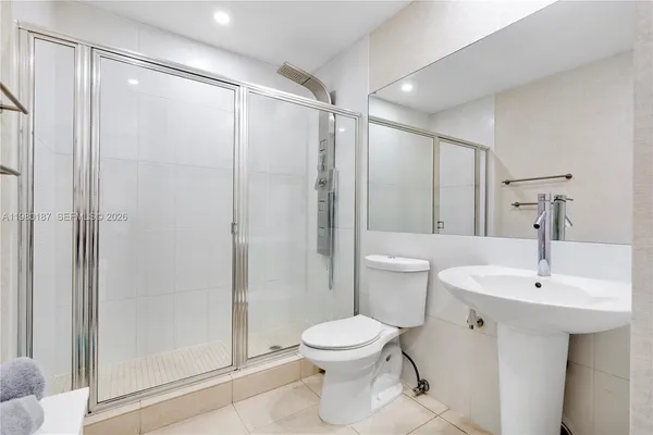 a bathroom with a sink toilet and shower