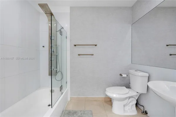 a bathroom with a toilet and shower
