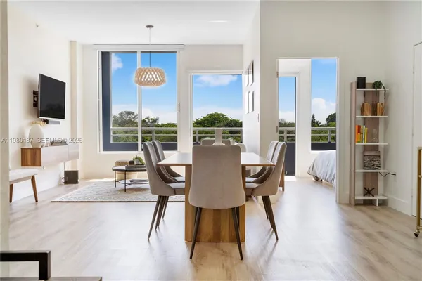 a view of a dining room with furniture window and wooden floor