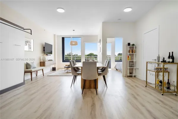 a dining room with furniture and wooden floor