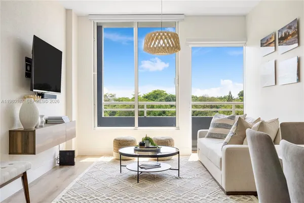 a living room with furniture and a flat screen tv