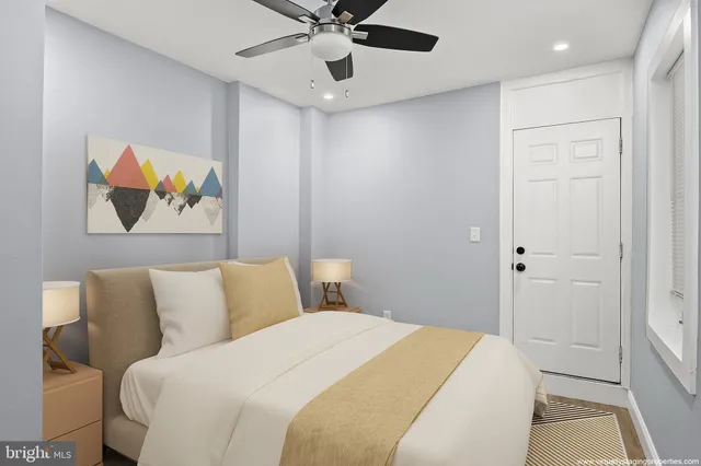 a bedroom with a bed and a painting on the wall