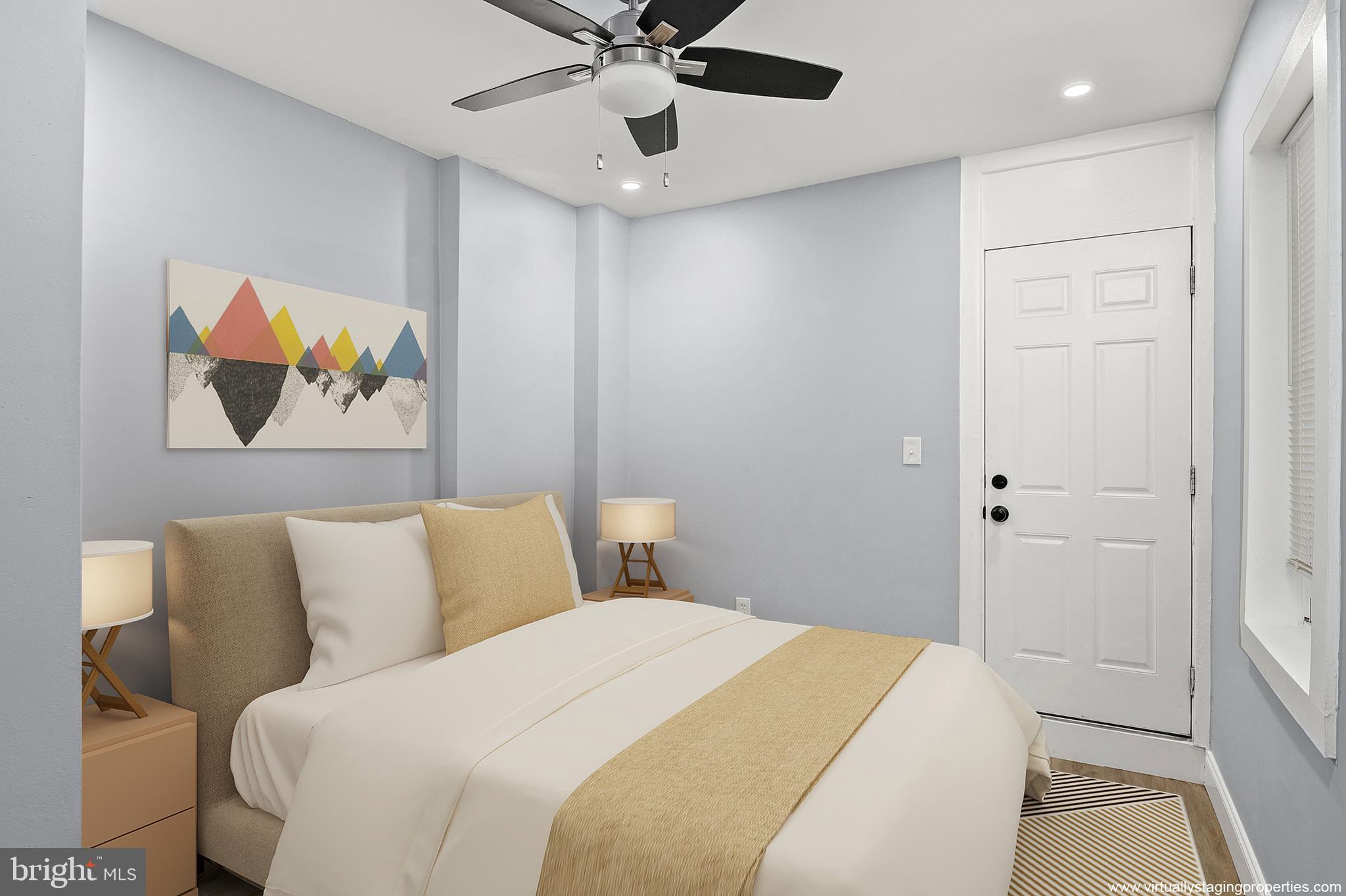 2112 Eastern Avenue Baltimore, MD 21231 - Photo 12 of 43 a bedroom with a bed and a painting on the wall