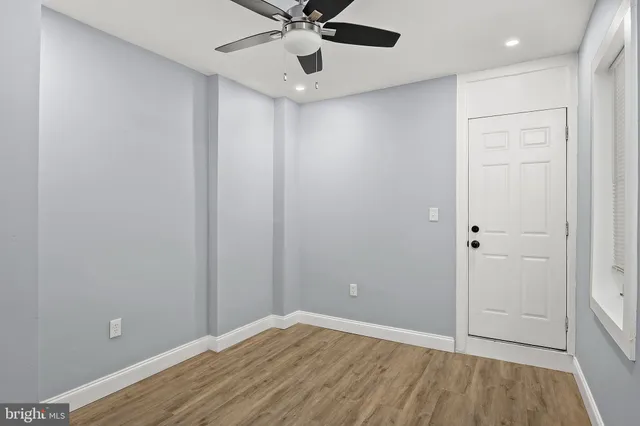 wooden floor in an empty room with a window