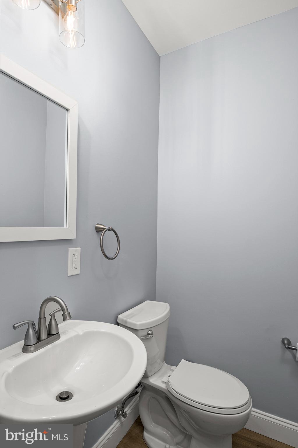 2112 Eastern Avenue Baltimore, MD 21231 - Photo 19 of 43 a bathroom with a toilet a sink and mirror