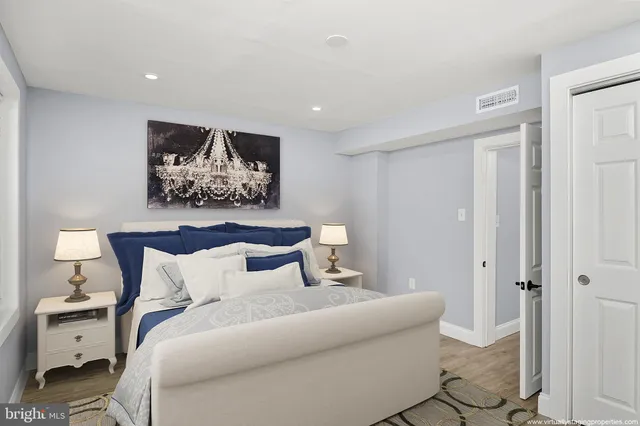 a bedroom with a bed and painting on the wall