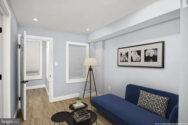 a living room with furniture a rug and a wooden floor