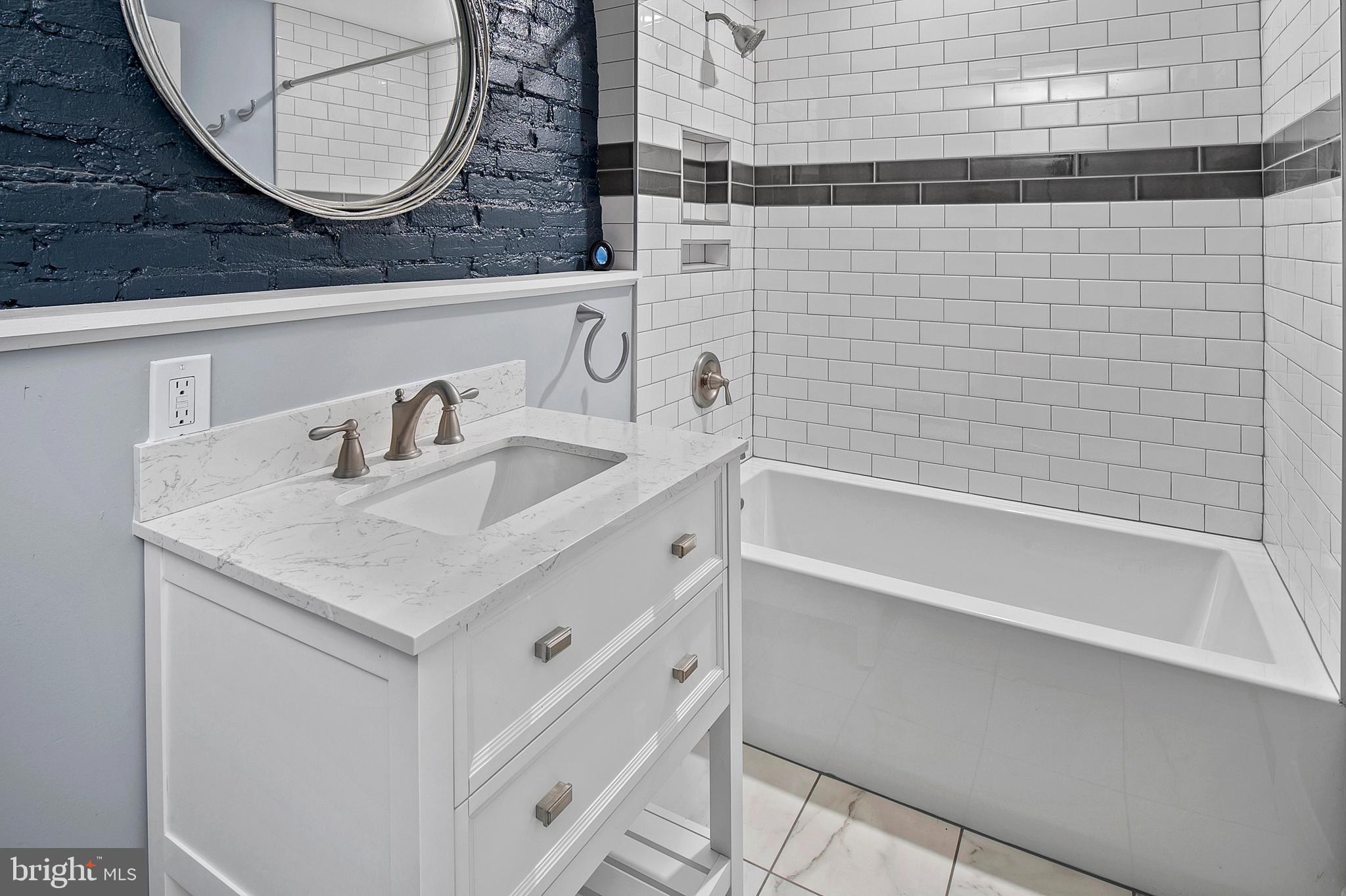 2112 Eastern Avenue Baltimore, MD 21231 - Photo 27 of 43 a bathroom with a sink and a mirror