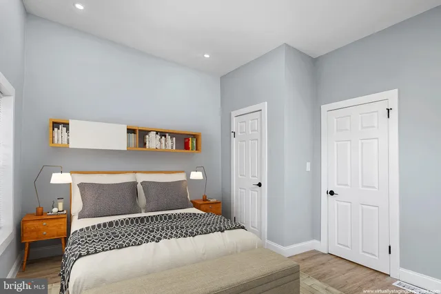 a bedroom with a bed and a painting on the wall