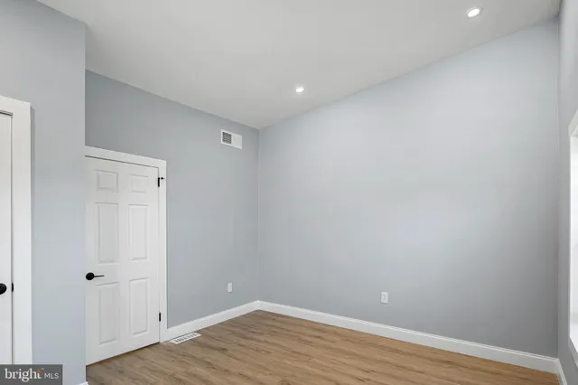 a view of room with wooden floor