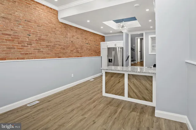 a view of a hallway with wooden floor and a fireplace