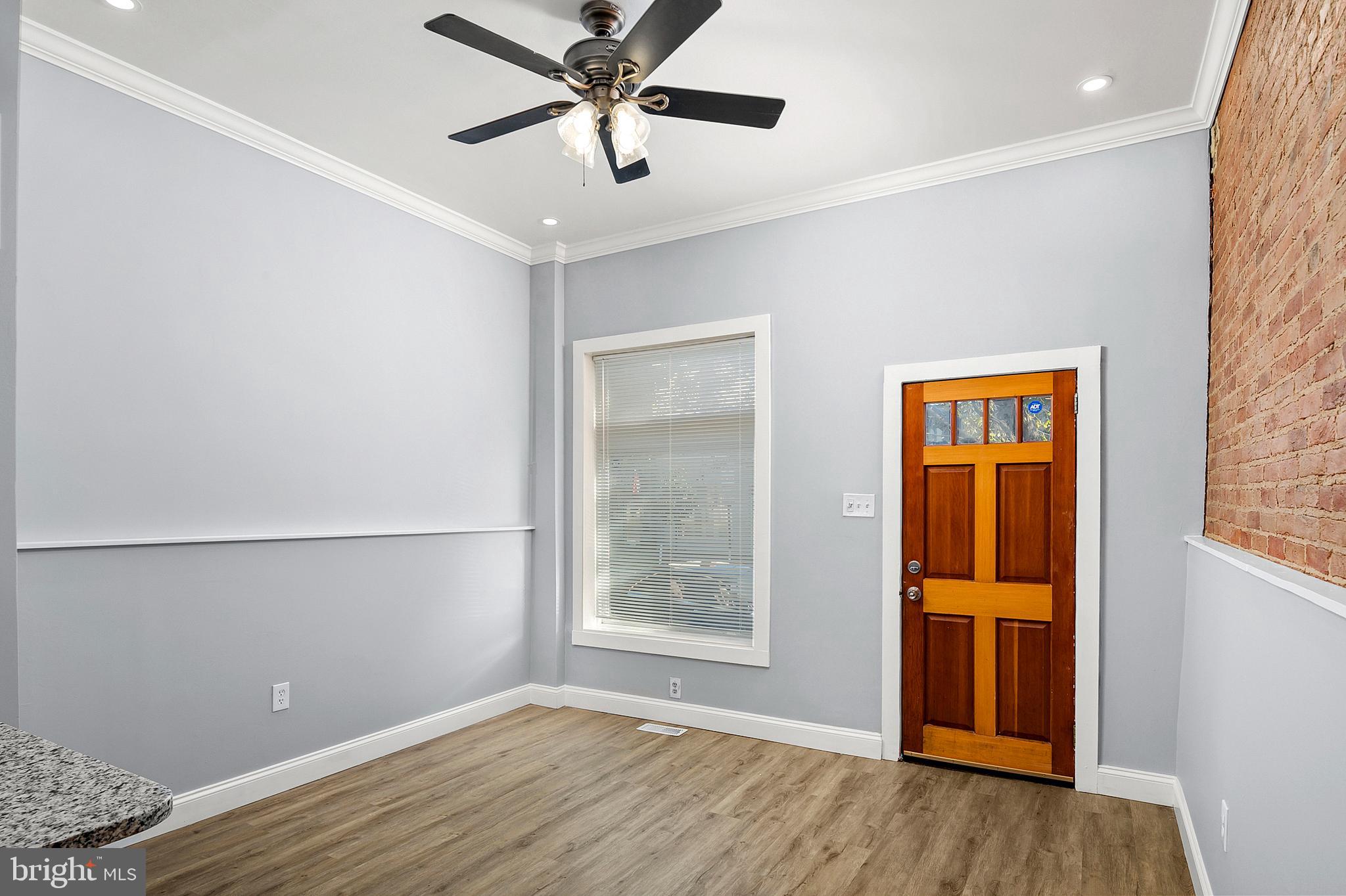 2112 Eastern Avenue Baltimore, MD 21231 - Photo 6 of 43 a view of an empty room with wooden floor and a window