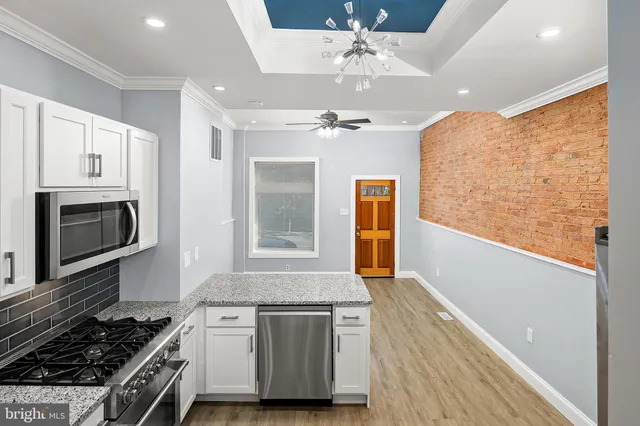 a kitchen with stainless steel appliances granite countertop a stove and a sink