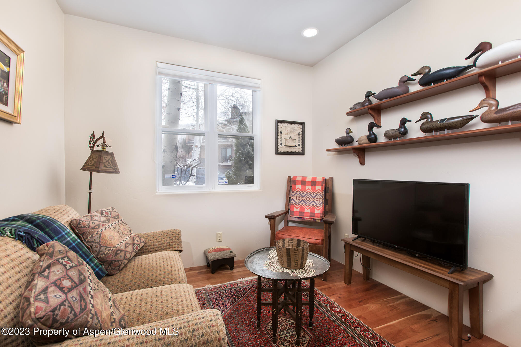 764 Promontory Lane Basalt, CO 81621 - Photo 16 of 43 a living room with furniture a flat screen tv and a window