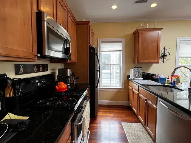 a kitchen with a sink stove and microwave