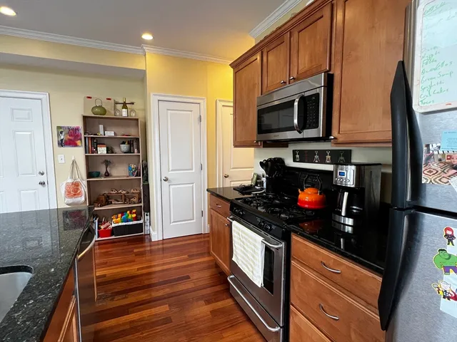 a kitchen with stainless steel appliances granite countertop a stove and a microwave