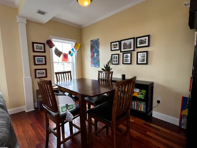 a view of a dining room with furniture and wooden floor