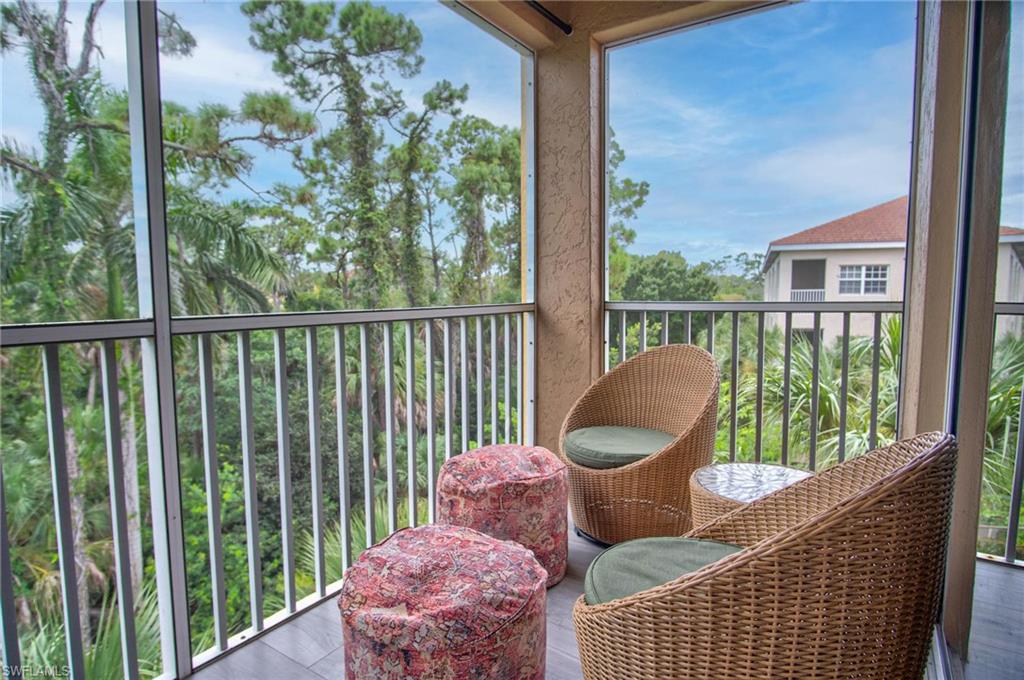 4450 Botanical Pl Circle, Unit 406 Naples, FL 34112 - Photo 11 of 16 a view of a chair in the balcony