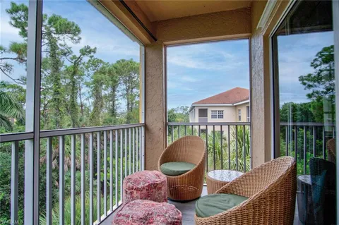 a view of a chair and table in the balcony