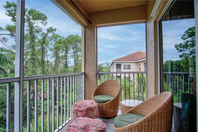 a view of a chair and table in the balcony