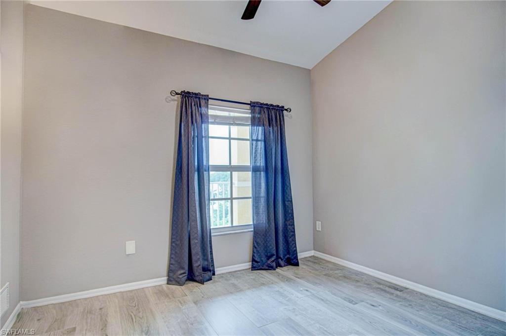 4450 Botanical Pl Circle, Unit 406 Naples, FL 34112 - Photo 10 of 16 an empty room with windows and closet