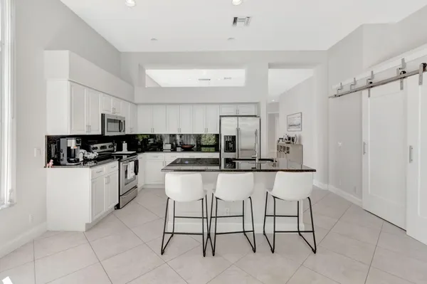 a kitchen with a sink and white cabinets