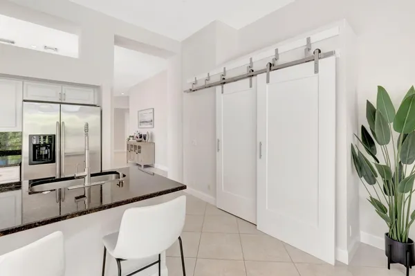 a kitchen with stainless steel appliances granite countertop a refrigerator and a sink