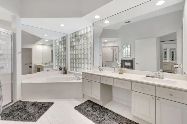 a large bathroom with a double vanity sink mirror and