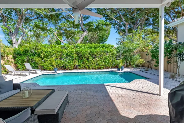 a view of a backyard with sitting area