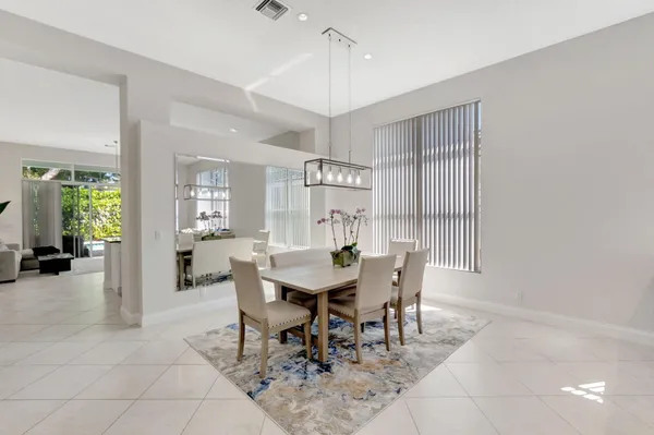 a view of a dining room with furniture and a chandelier