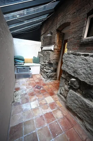 a balcony with table and chairs