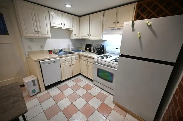 a kitchen with a cabinets and white appliances