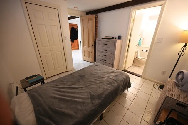 a bedroom with a bed and a mirror