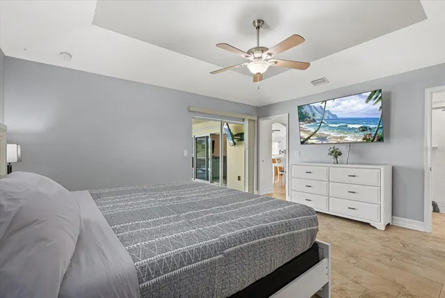 a bedroom with a bed and a chandelier