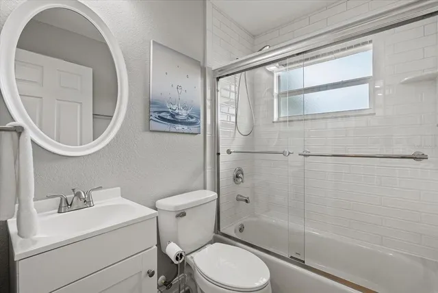 a white toilet sitting next to a bathroom sink