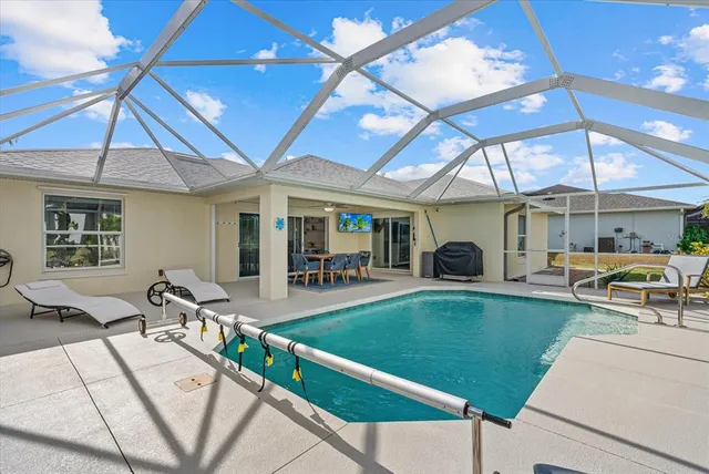 a view of a house with backyard and sitting area
