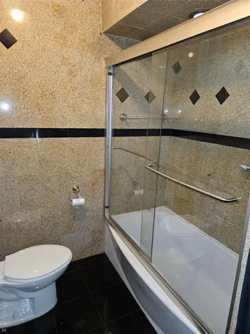 a bathroom with a toilet and a shower