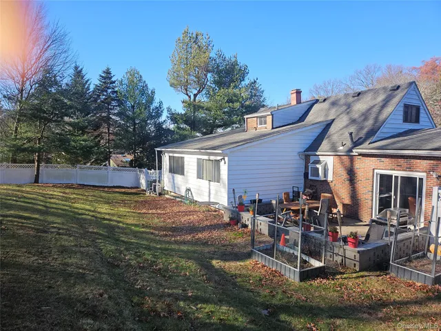 a view of a house with backyard and sitting area